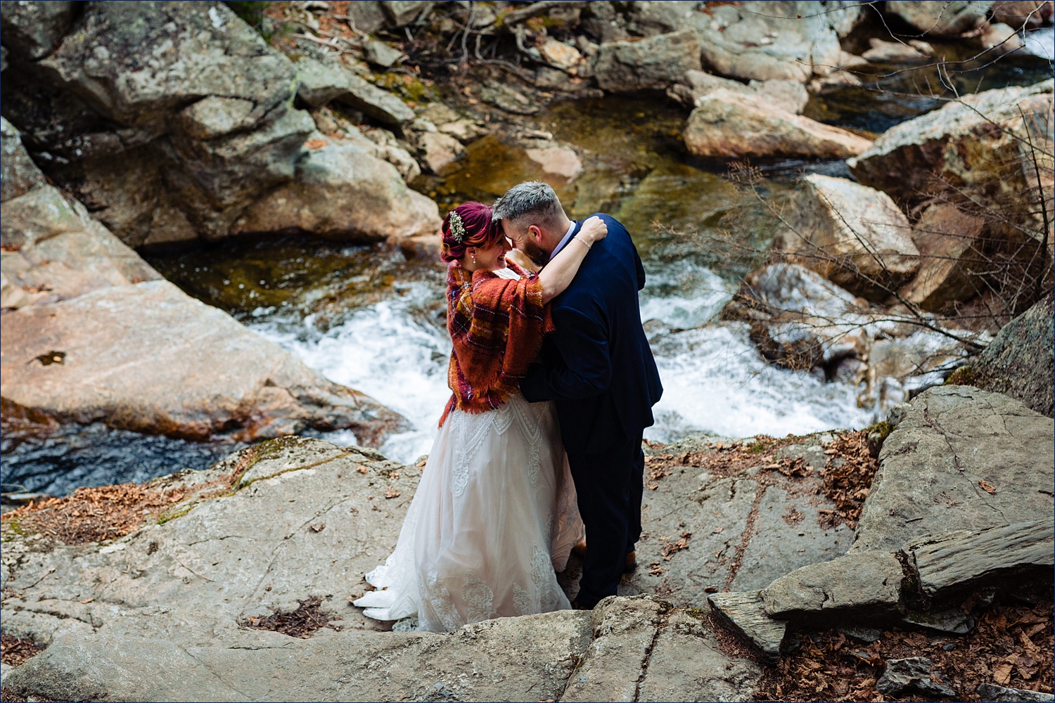 A cuddle at the Glen Ellis Falls on a chilly fall elopement day