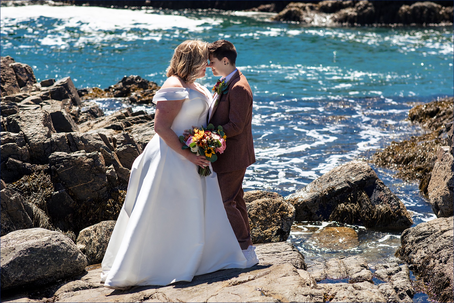 Getting in close with the blue ocean behind them on their Ogunquit Maine elopement