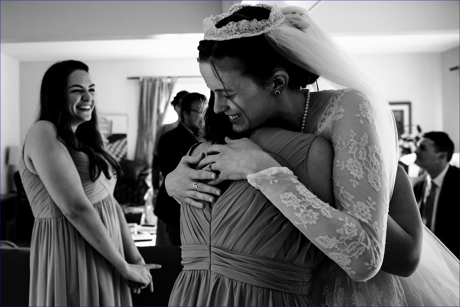The bride hugs her best friends after getting into her wedding day gear in NH
