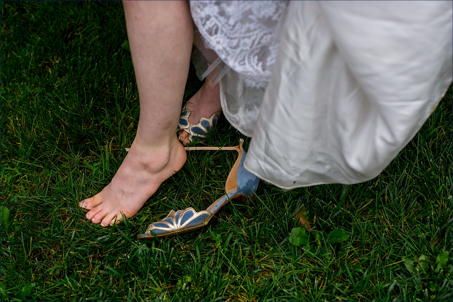 A wet wedding day means wiping those toes in the grass on the wedding day