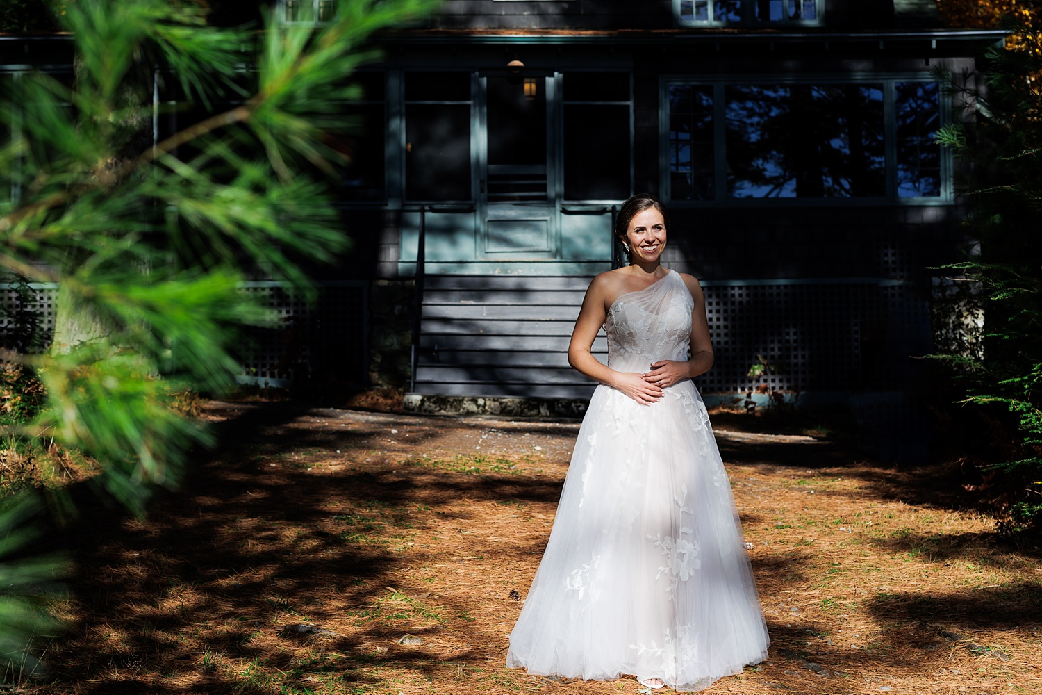 The bride in her wedding dress in front of her cabin on the wedding day