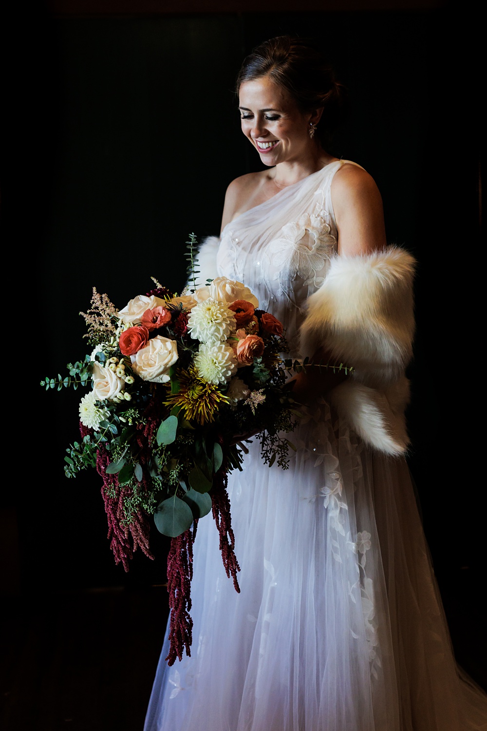 The bride and her flowers on her fall wedding day in Maine