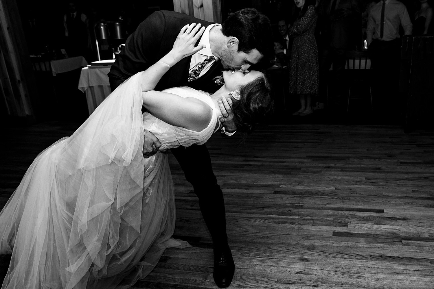 A dip and a kiss at their wedding reception in Maine