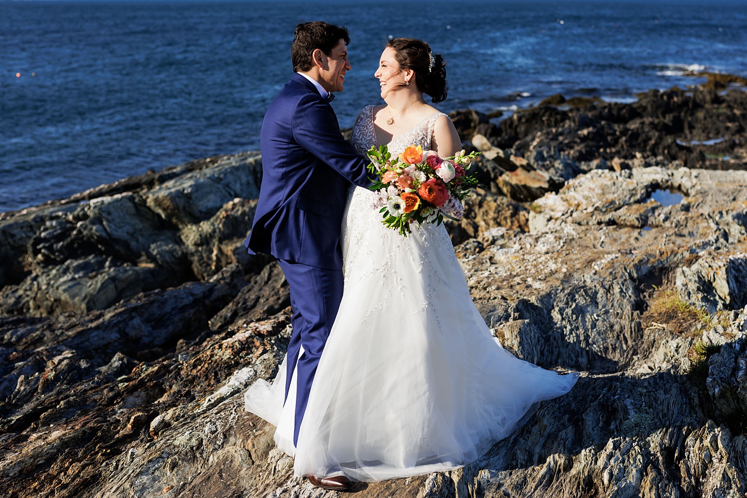 Bride and groom cuddle up at Trundy Point in Cape Elizabeth Maine