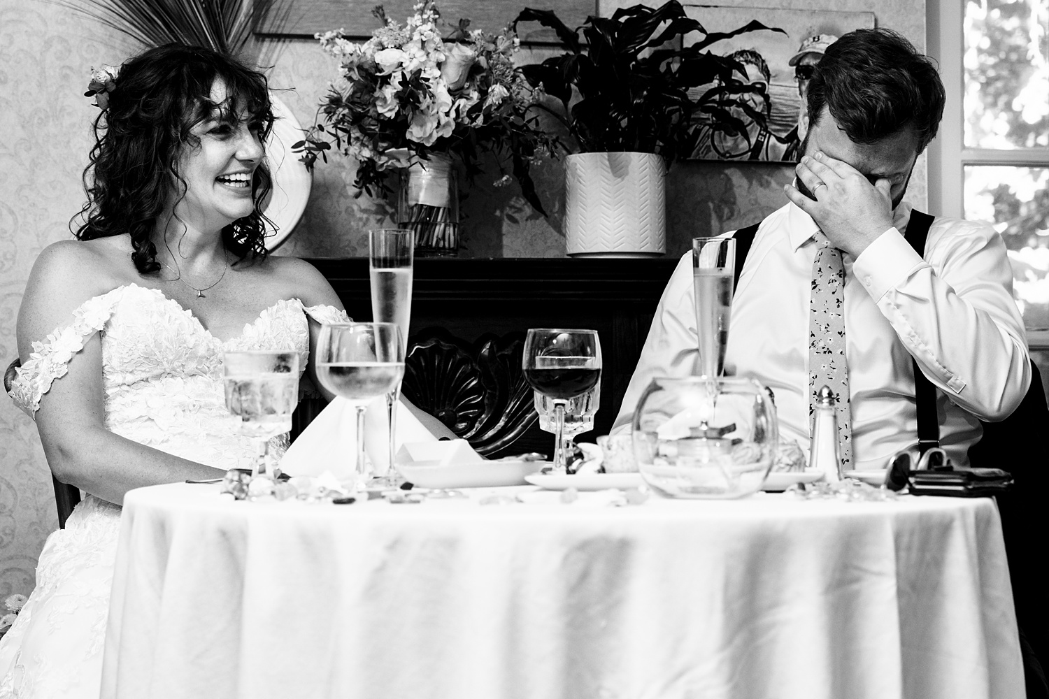 The couple listen to toasts on their wedding day