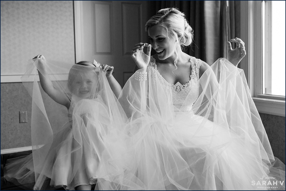 The bride and her flower girl play with the tulle on their dresses in Portsmouth, NH