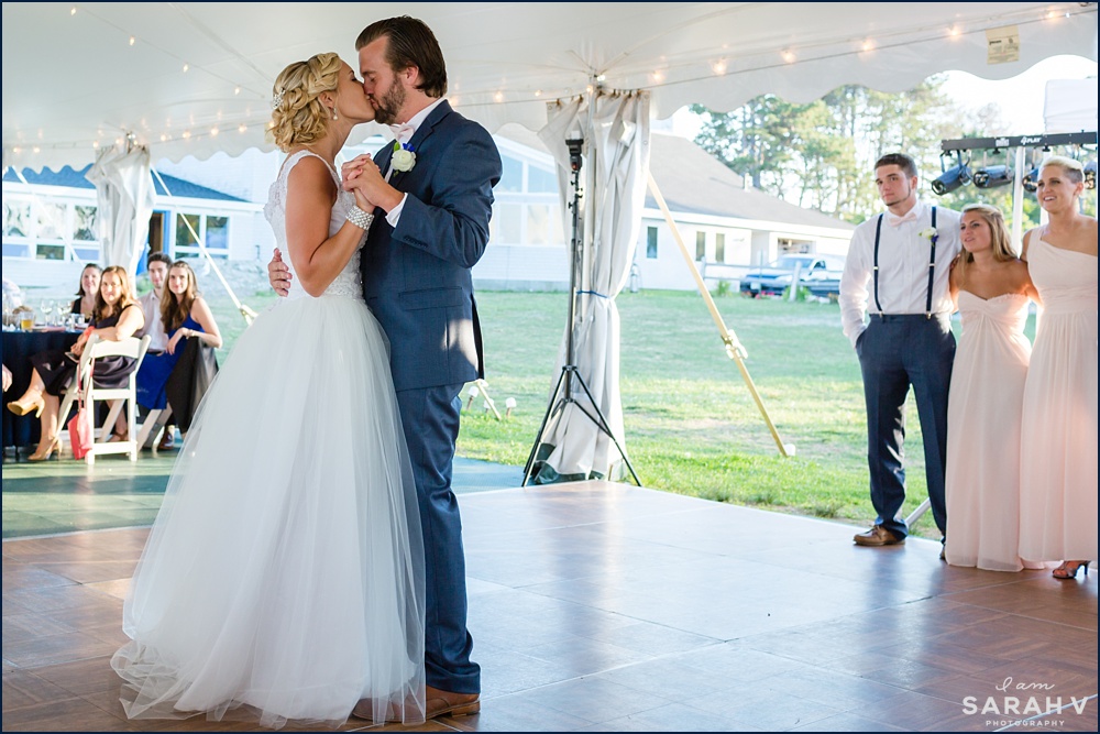 The bride and groom share a kiss as their tented reception begins