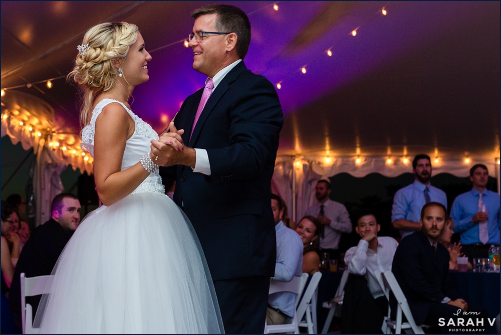 SThe bride and her father dance together under the wedding reception tent