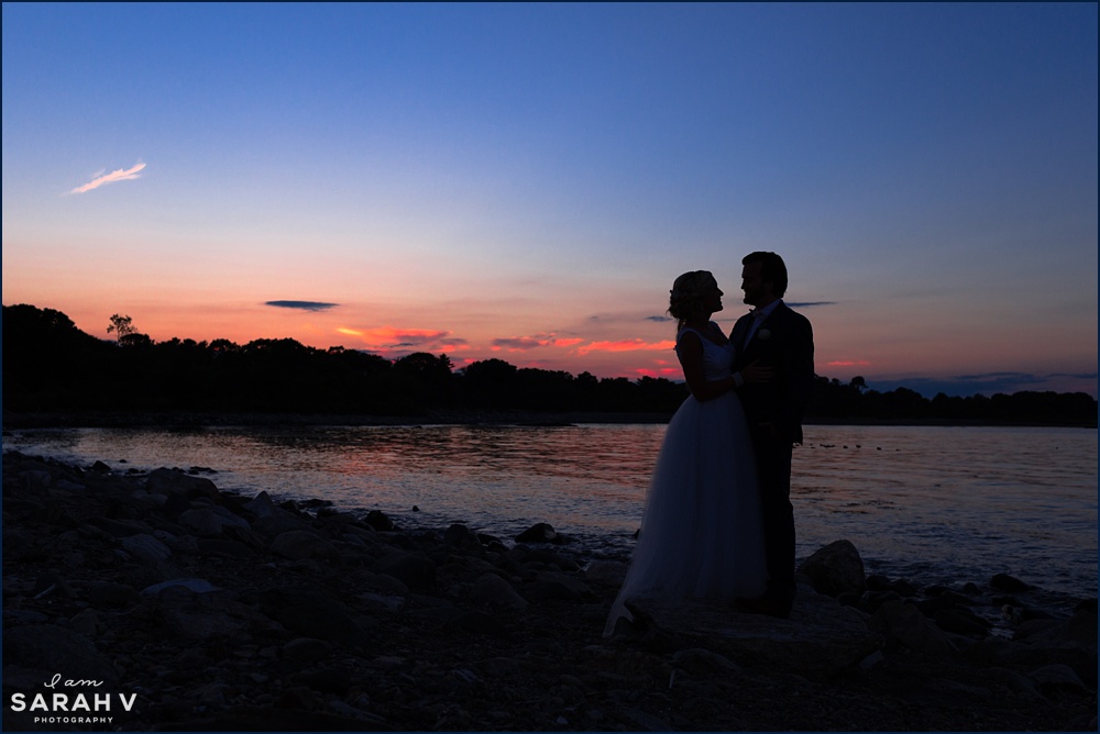 The bride and groom get a silhouette picture in front of the sunset sky on their wedding day at Odiorne Point Park
