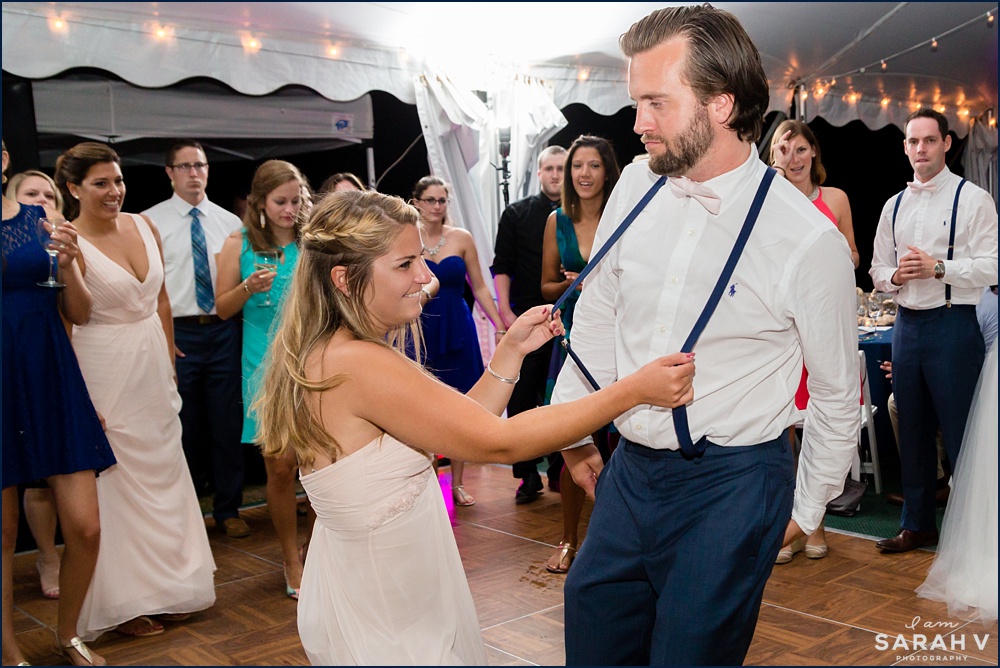 The groom and the maid of honor get into the party under the tent