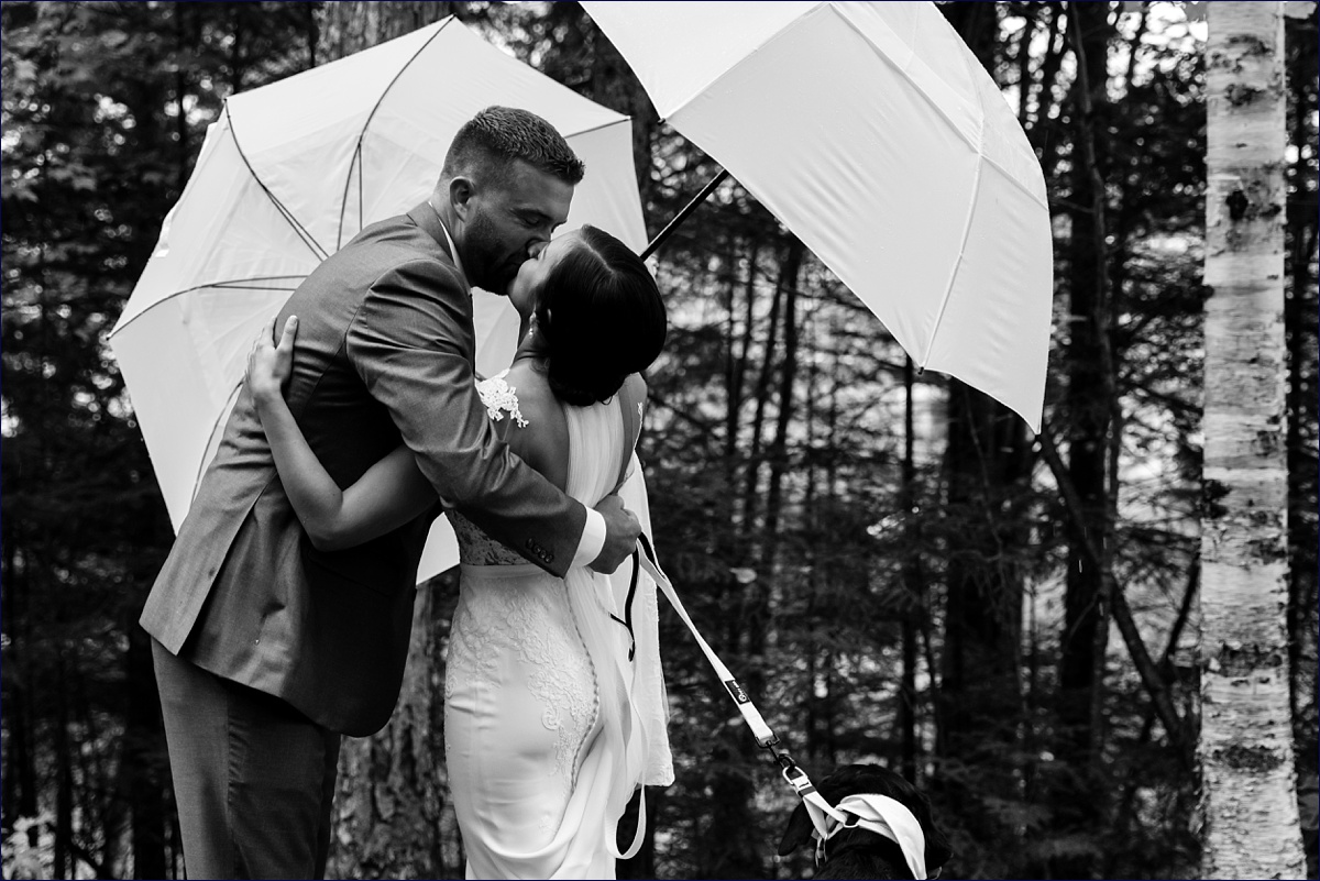 Waterville Valley New Hampshire Wedding bride and groom share a kiss during their rainy wedding day first look