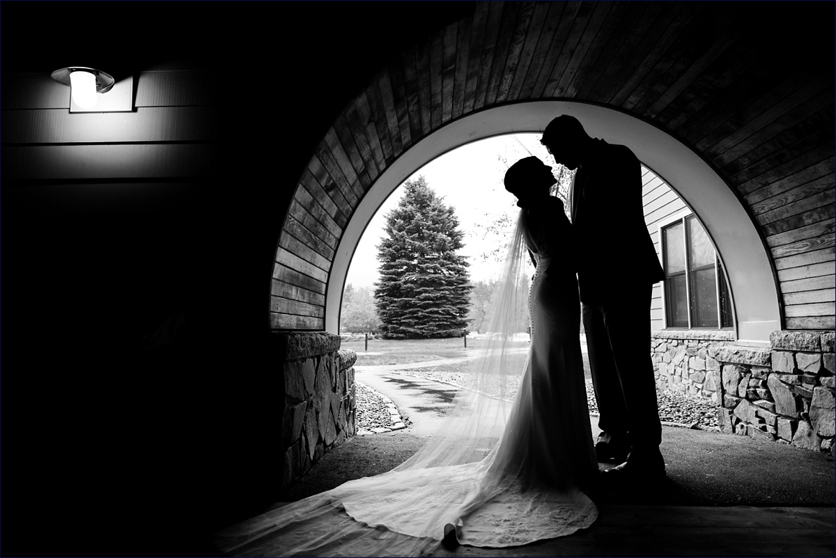 Waterville Valley New Hampshire Wedding bride and groom's silhouette under the archway