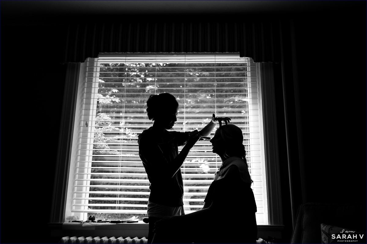 A silhouette of the bride getting ready for her wedding day in Bar Harbor Maine