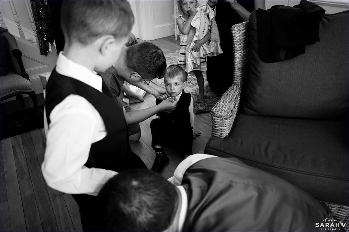 The ringbearers begrudgingly get into their wedding day attire with the help of their parents