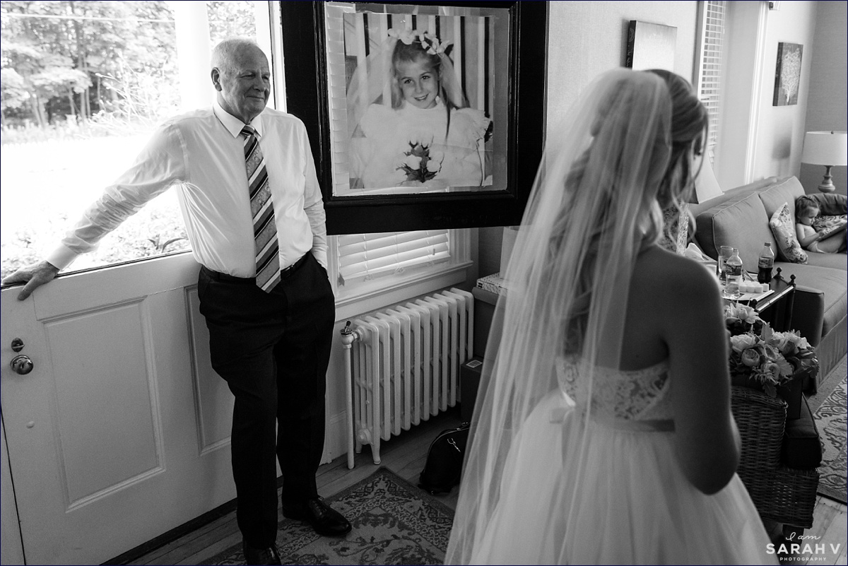 The father of the bride watches as his daughter gets ready to head to the wedding day ceremony in Bar Harbor Maine