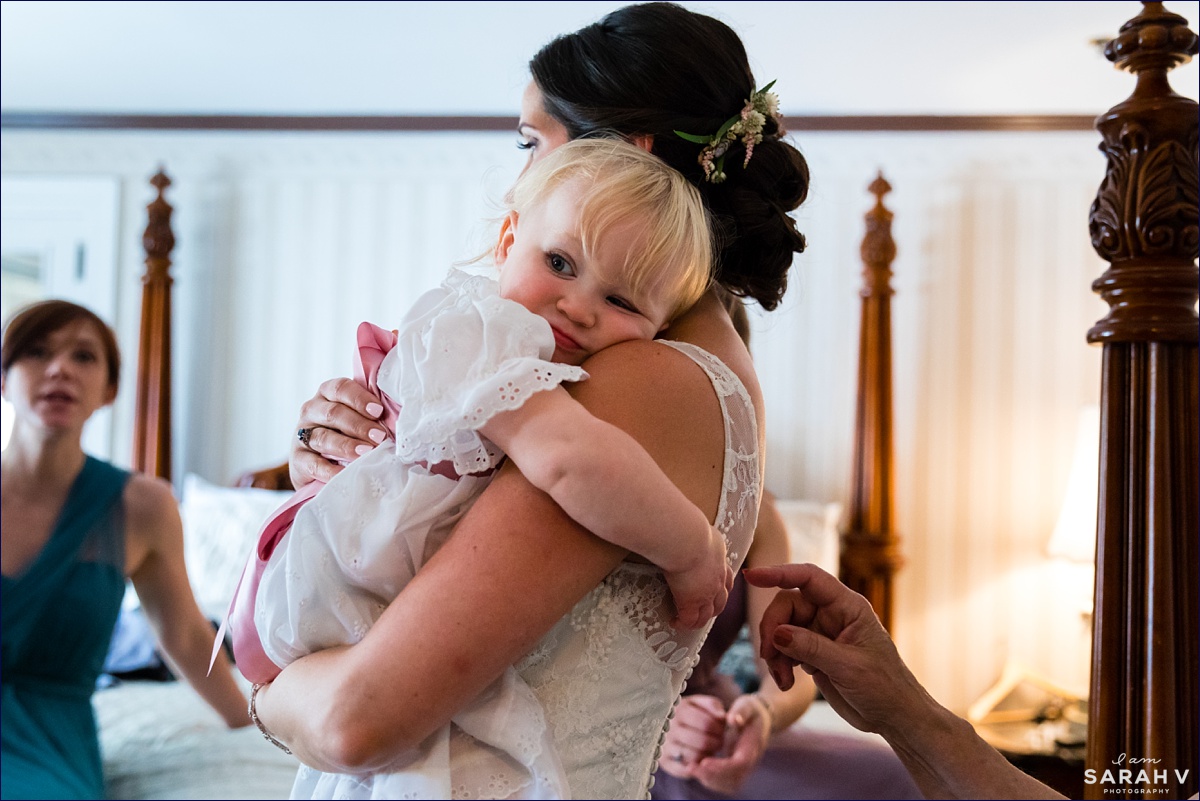 The bride hugs her young neice while in her wedding gown at the Ivy Manor Inn in Bar Harbor Maine