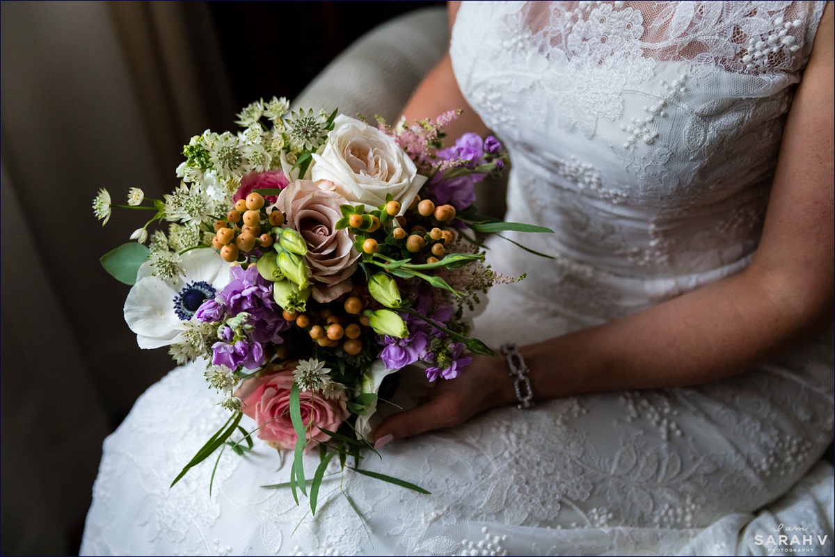 The bride sits with her wedding day flowers before she heads to the wedding ceremony