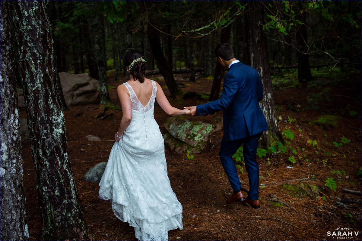 The bride and groom run into the forest of Acadia after their Bar Harbor wedding