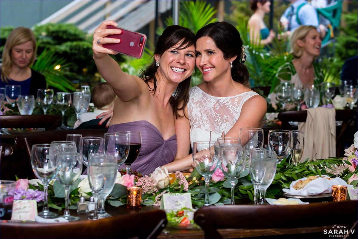 The bride and her sister take a selfie at the Bar Harbor wedding reception on Mount Desert Island