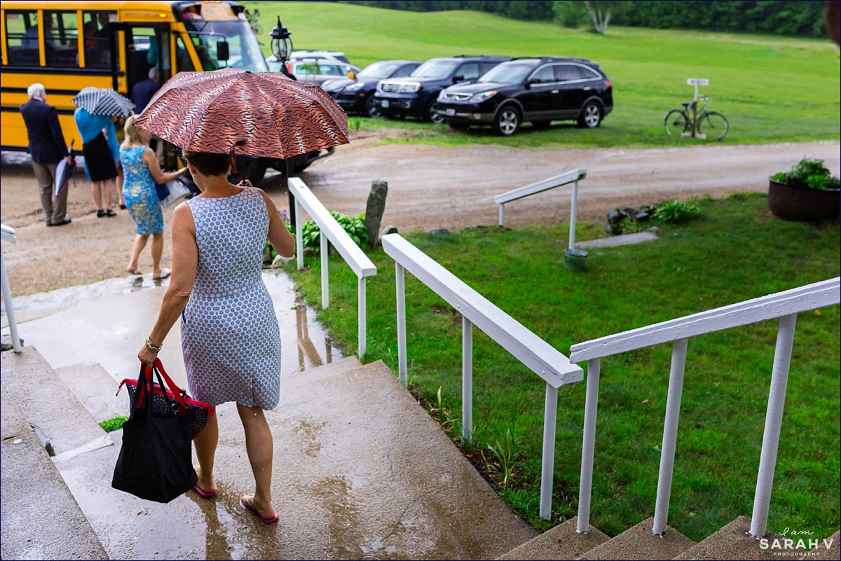 Guests leave the Preserve to head to Squam Lake in the rainstorm where the buses await them