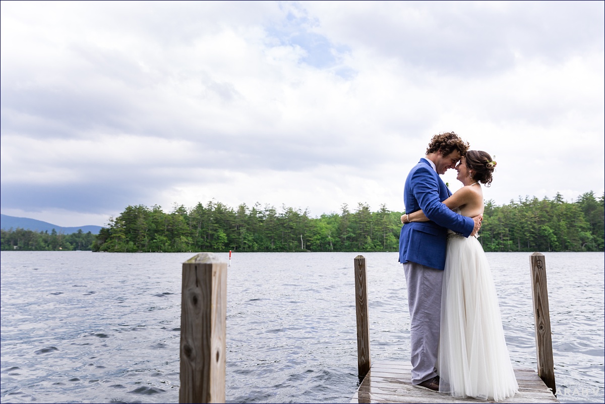 The bride and groom stand on one of the docks on the island and take in that just married feeling
