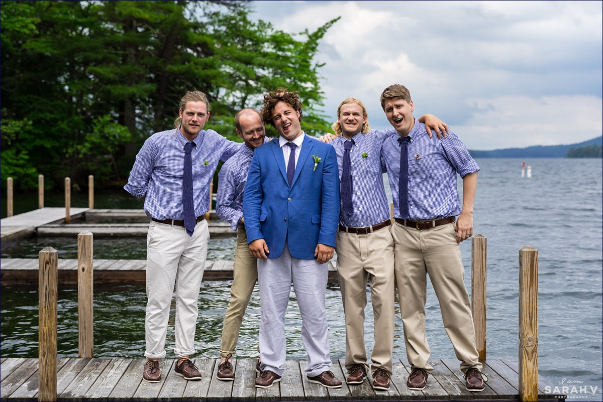 The groom and the groomsmen stand on the docks and have fun with a photo of them all over the water