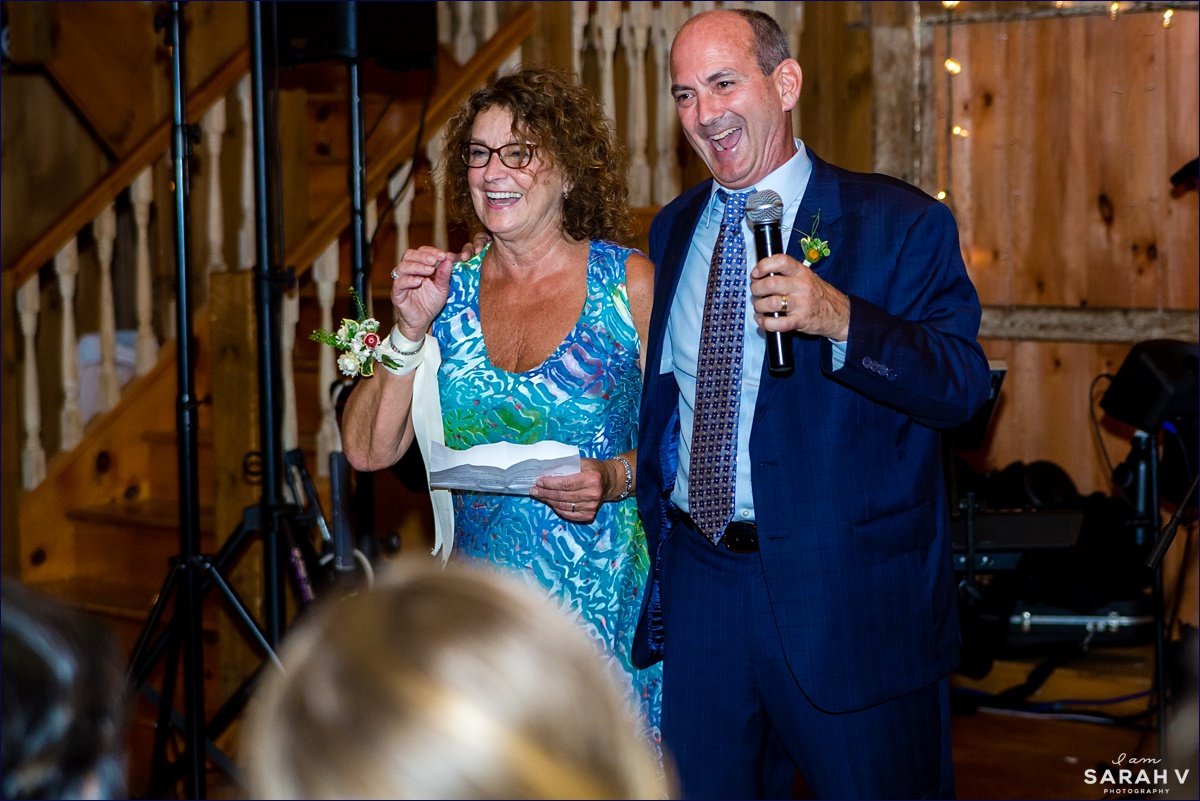 Parents of the newlyweds laugh while toasting the couple in the White Mountains of New Hampshire