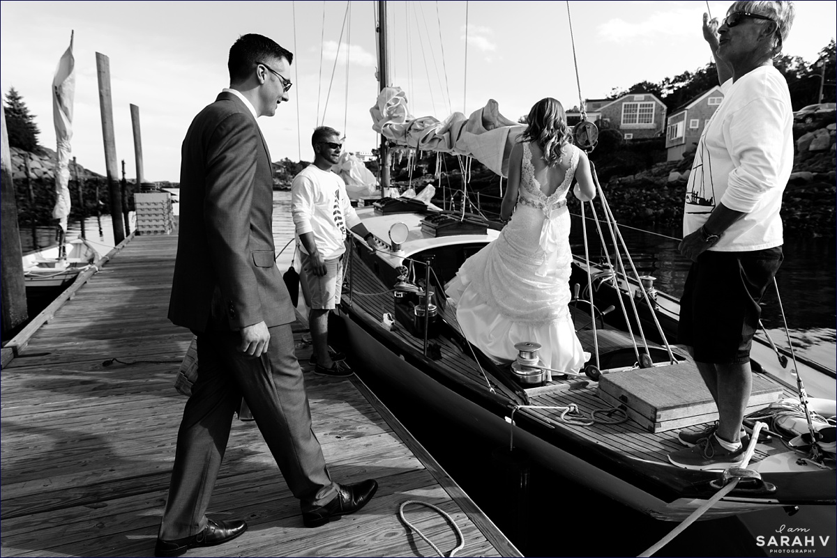 The bride and groom board the sailboat in Perkin's Cove for their elopement