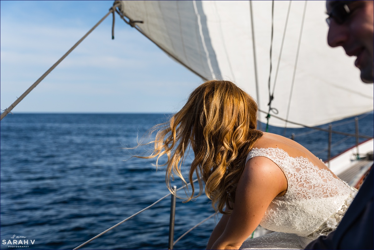 The bride's hair blows in the wind on her wedding day aboard a sailboat