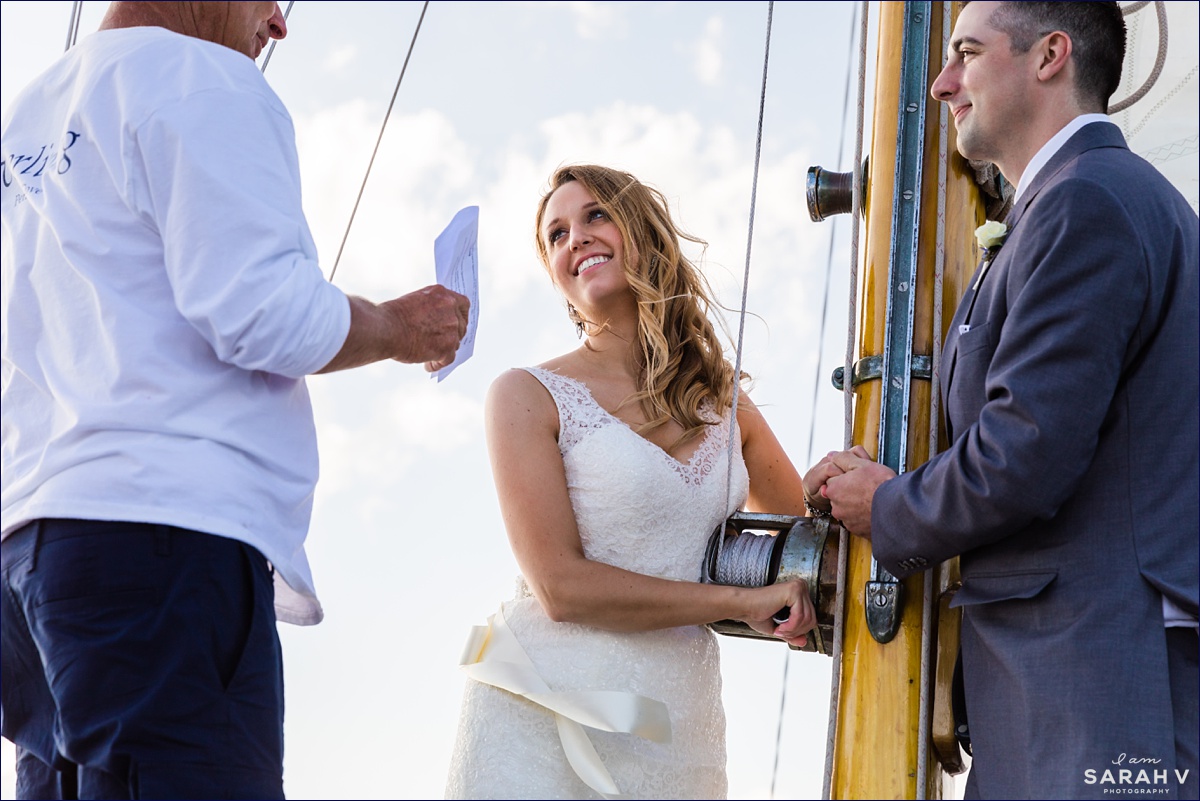 Silverlining Sailing Sailboat Elopement the couple listen to Captain Jack as he officiates their ocean wedding