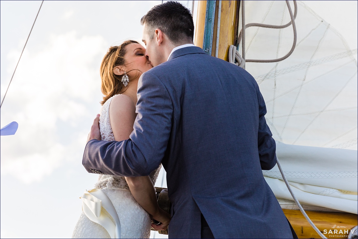 The bride and groom share a first kiss after they are officially married aboard a sailboat in Maine