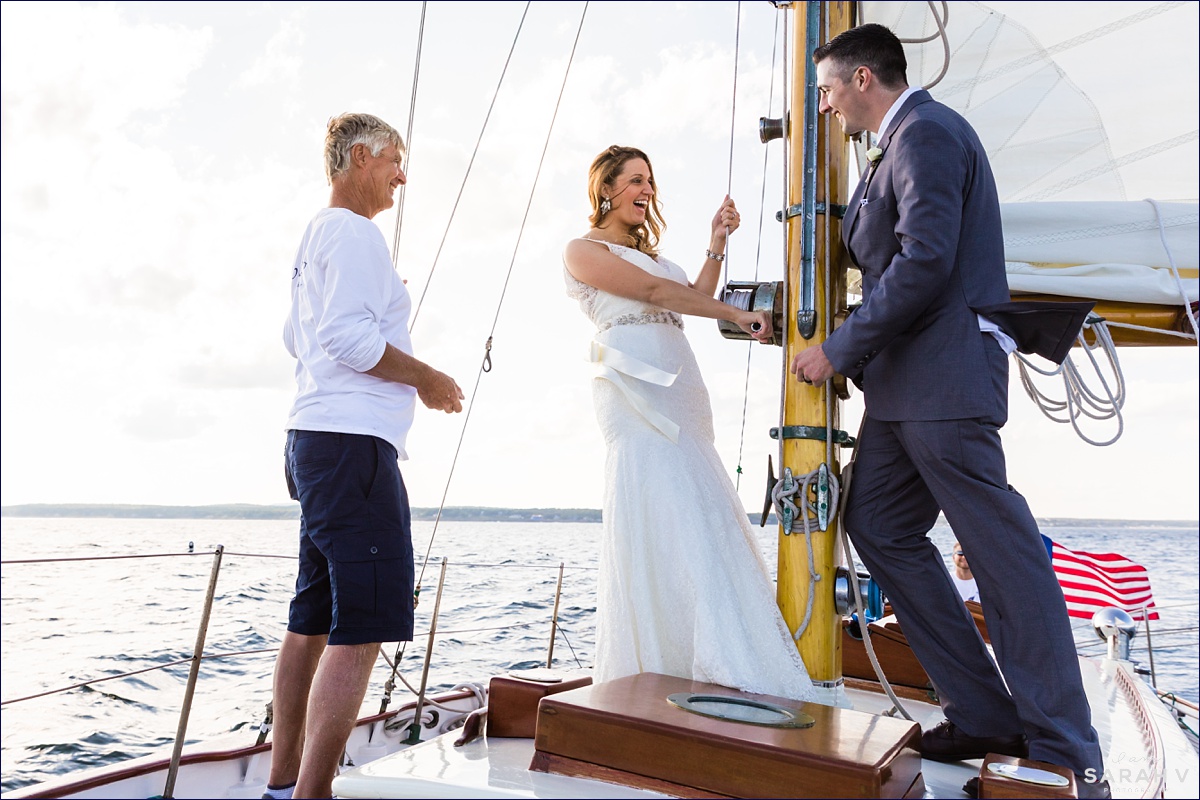 Silverlining Sailing Sailboat Elopement the couple laugh aboard the classic boat on their wedding day