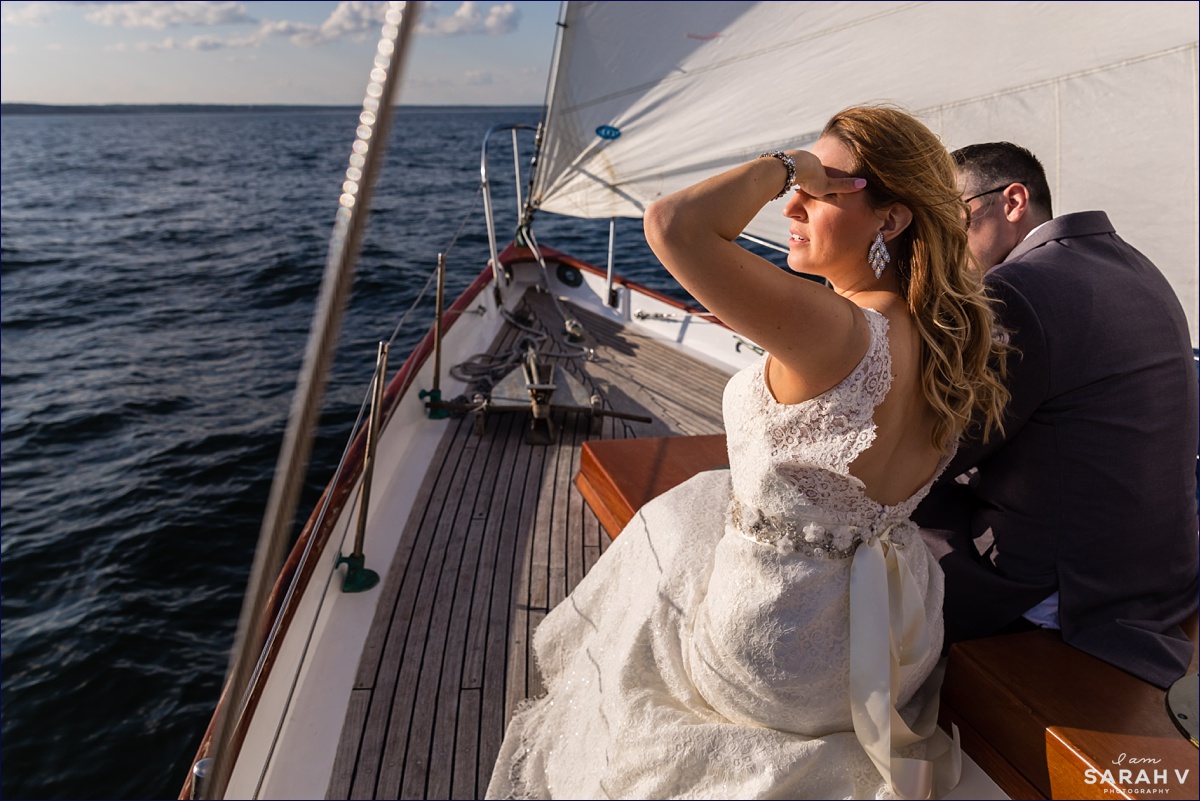 The bride looks out over the water off the coast of Perkin's Cove Maine after her wedding