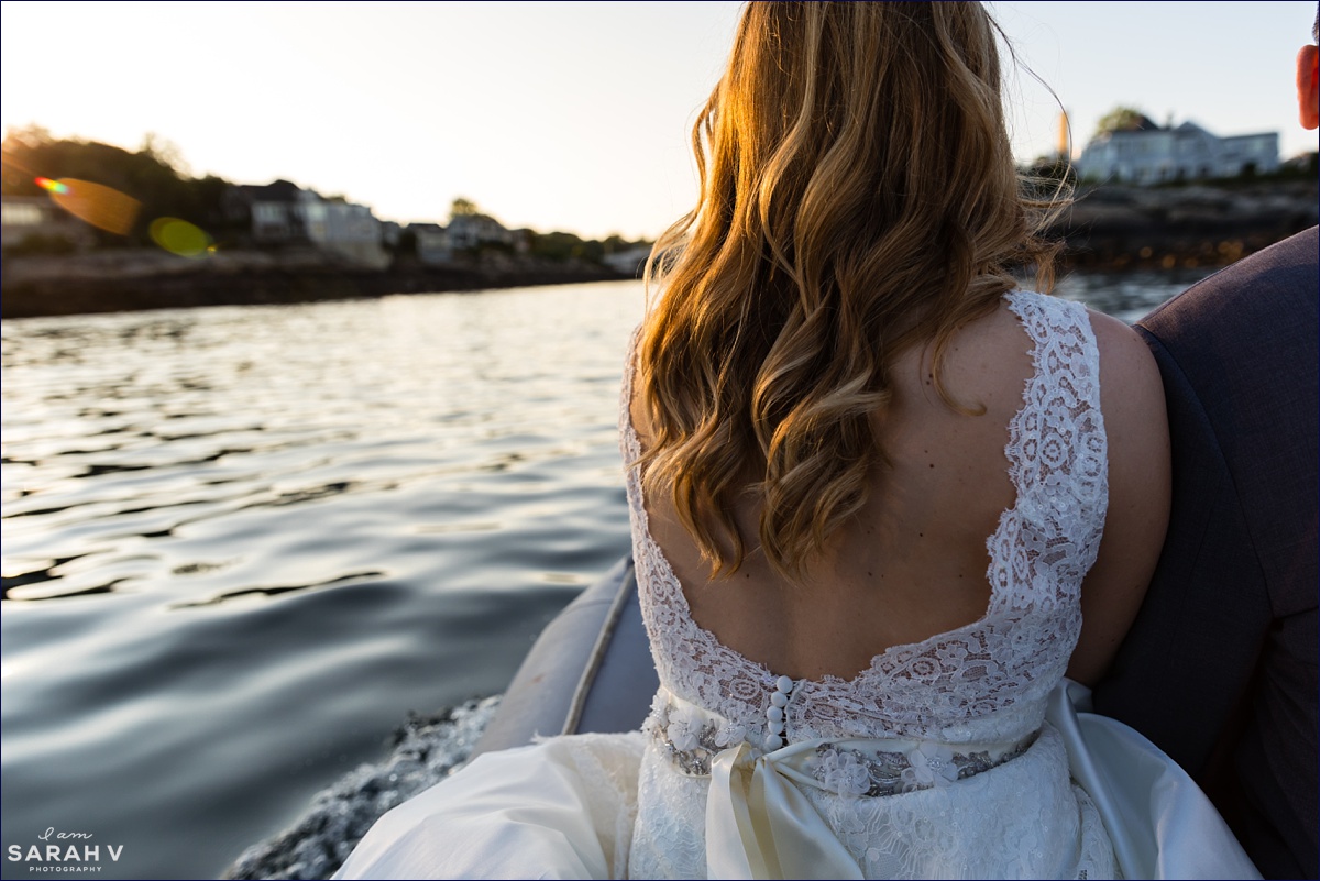 The bride rides in from the Silverlining Sailing Sailboat at sunset after they elope off the coast of Maine