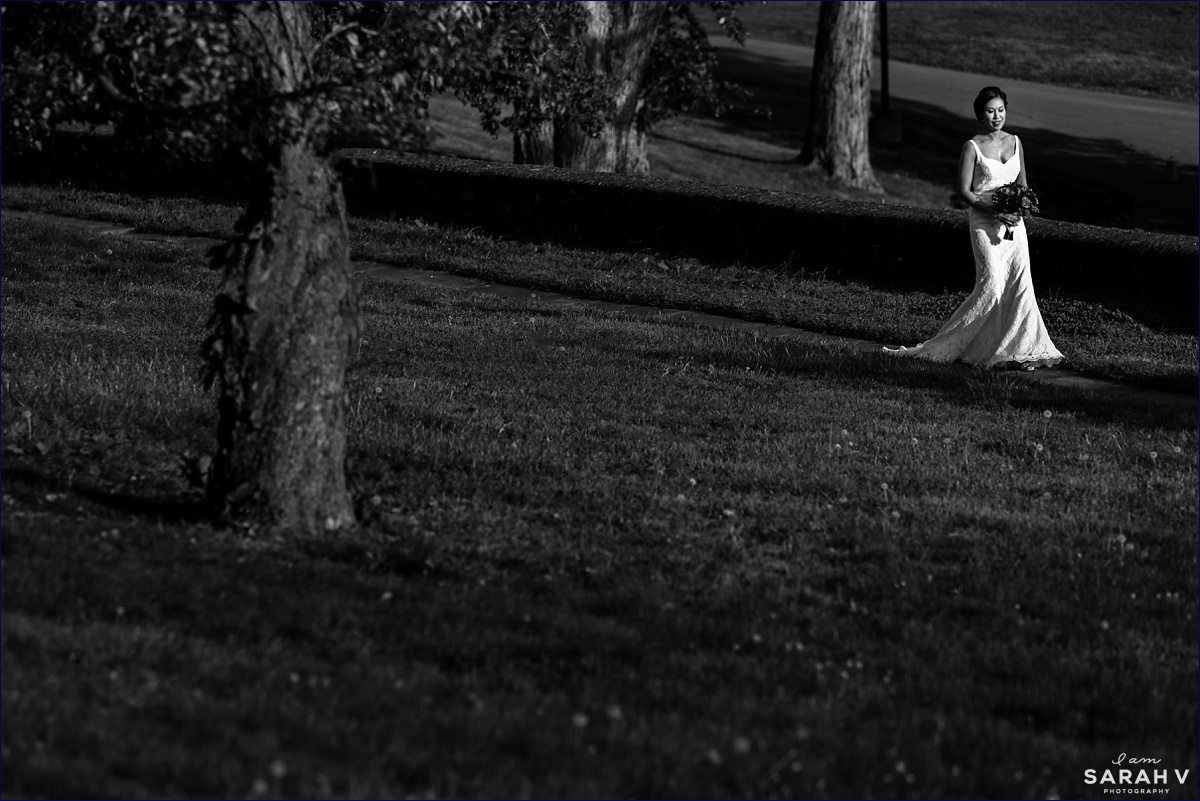 The bride walks into the wedding ceremony outside on the lawn