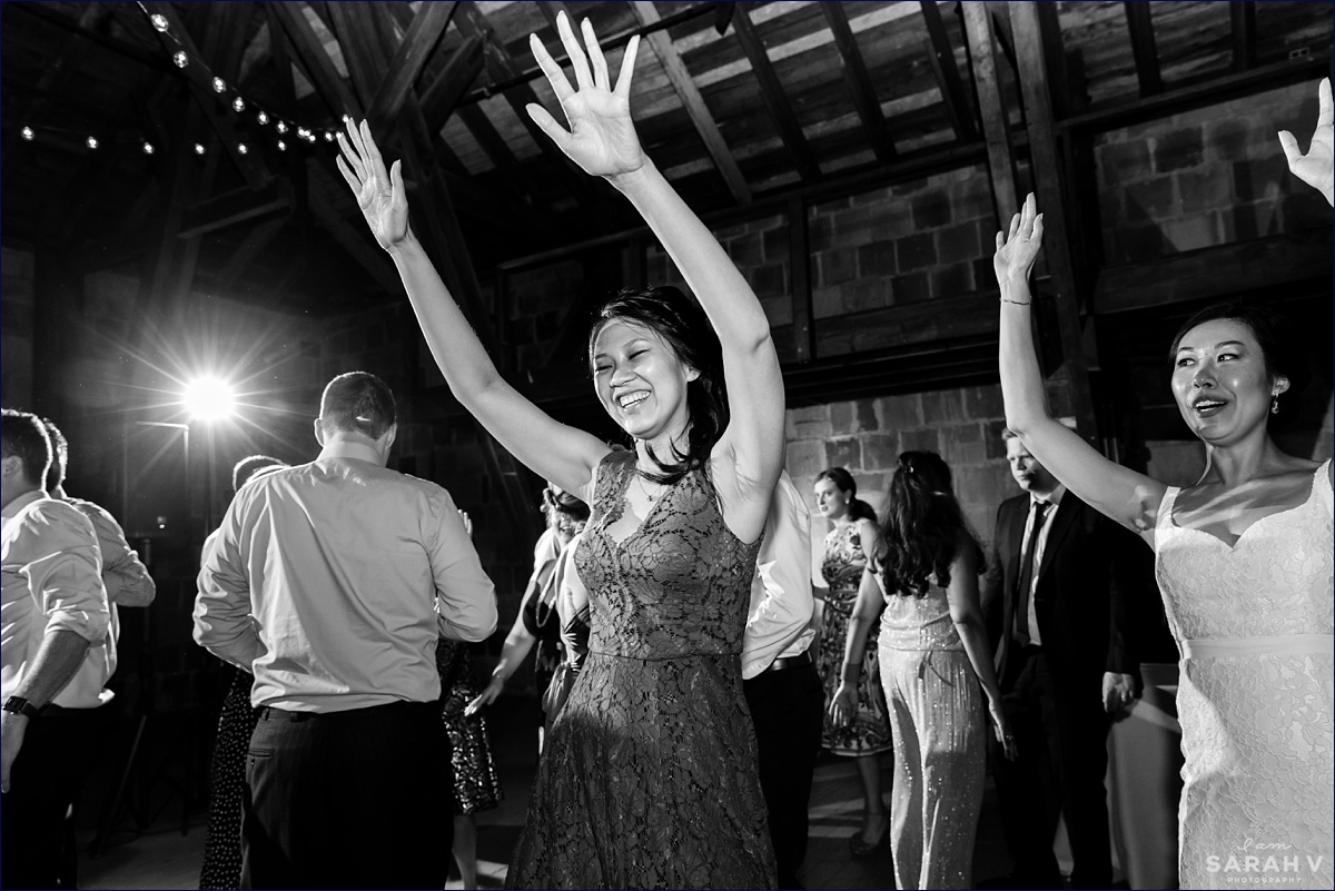 The Barn at Crane Estate wedding reception with the bride's sister getting into the music on the dance floor