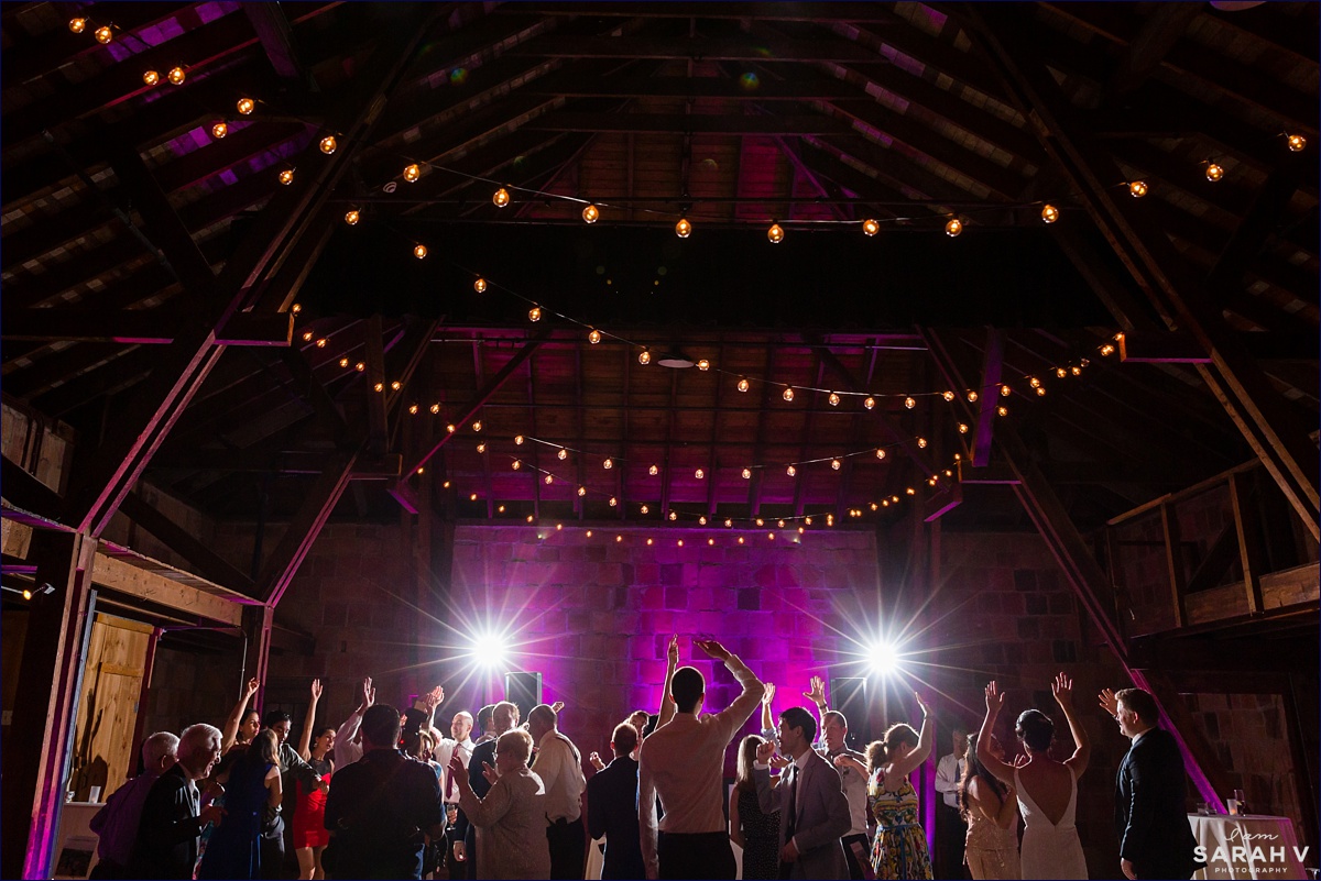 The Barn at Crane Estate wedding the reception is in full swing with the uplighting and the dancers