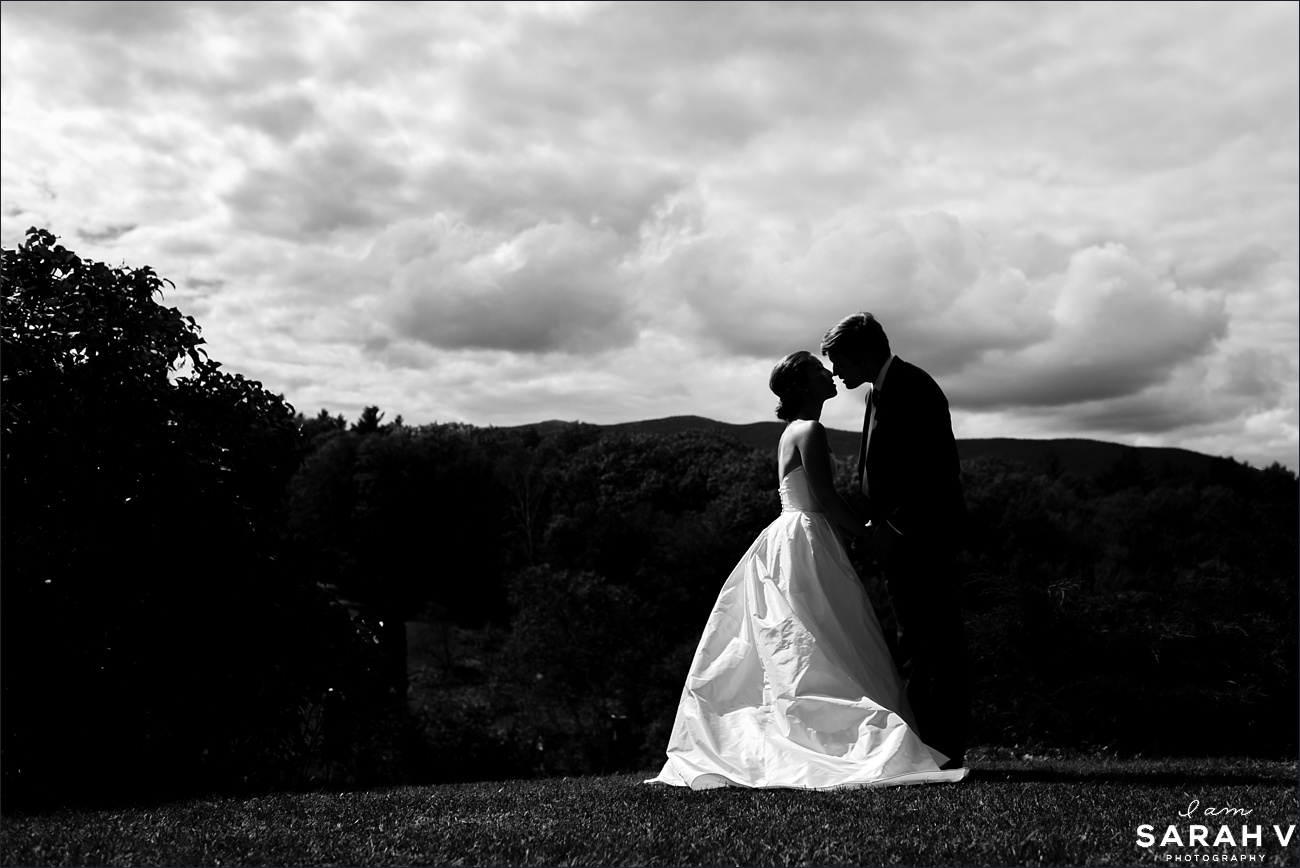 Mount Monadnock New Hampshire Wedding the bride and groom lean in for a kiss in front of the mountain range on their wedding day