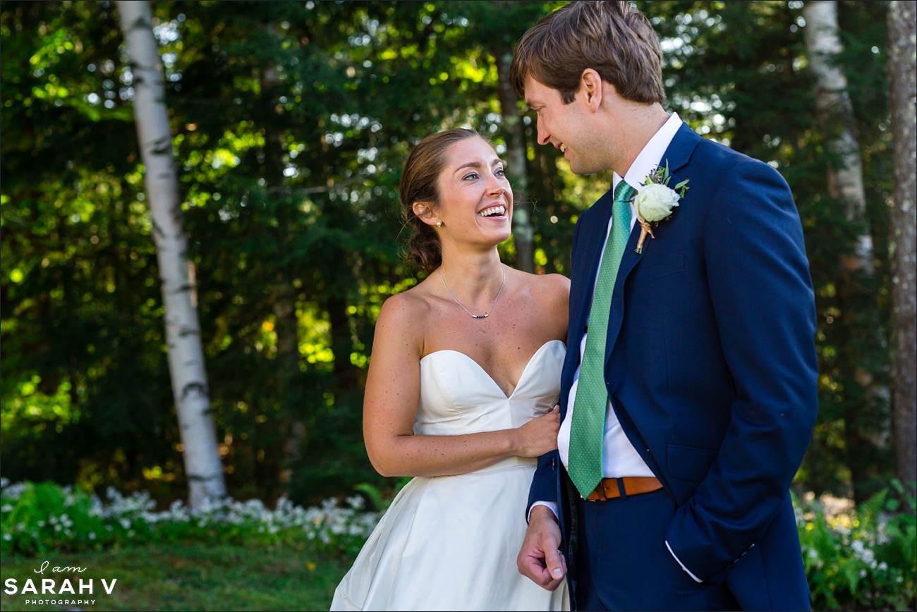 New Hampshire Wedding Photographer the bride and groom smile at one another after their wedding ceremony in the summer