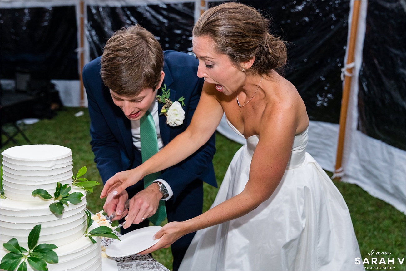 The bride and groom delight in the cake cutting at their wedding reception