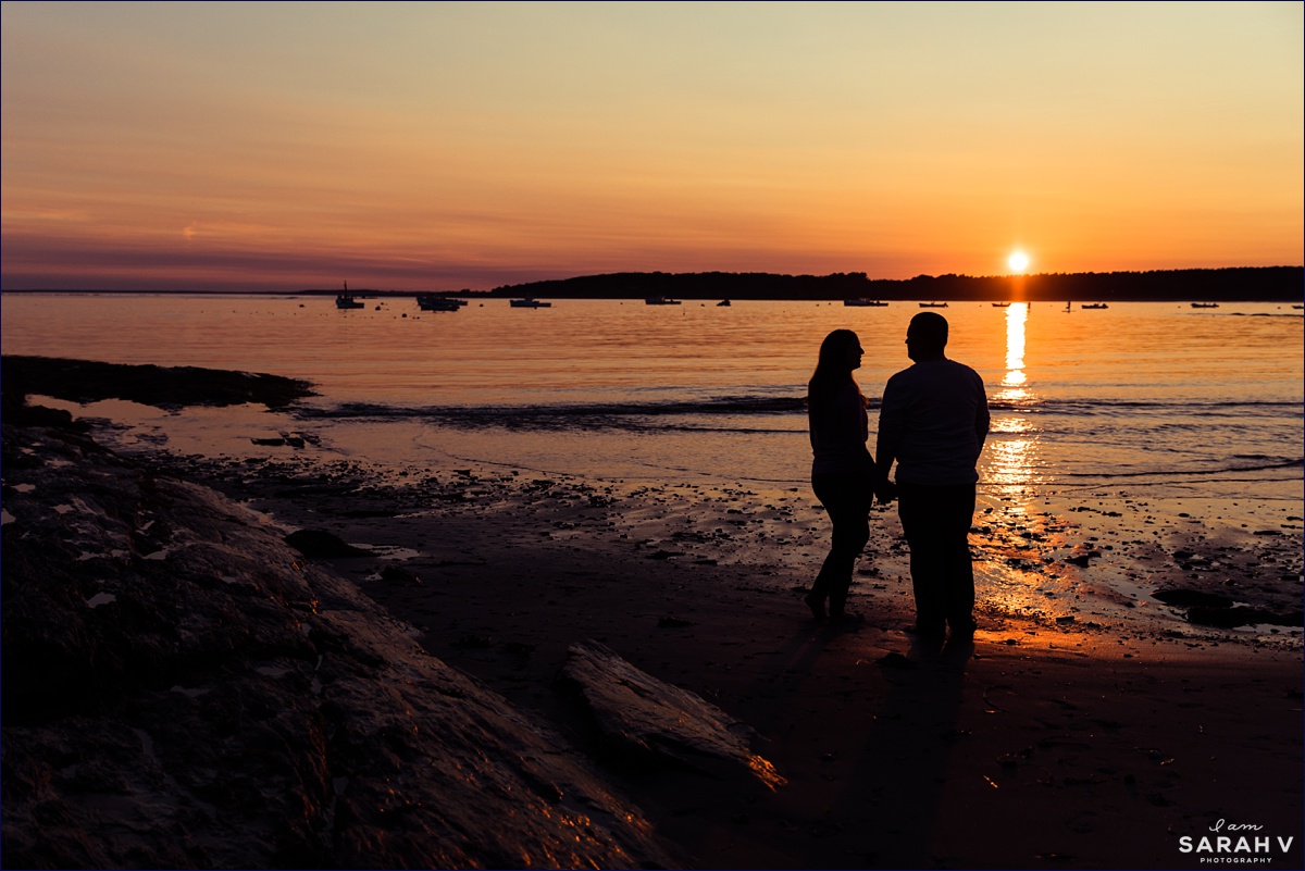 A silhouette of the couple down by the water in Coastal Maine
