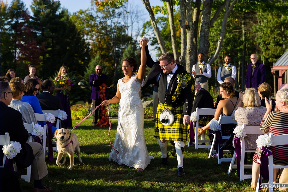 William Allen Farm wedding the bride and groom are married and they walk back up the aisle with their dog while they celebrate their Maine wedding nuptials