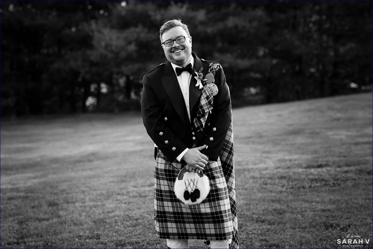 The groom wears his custom made kilt at his fall wedding in Maine