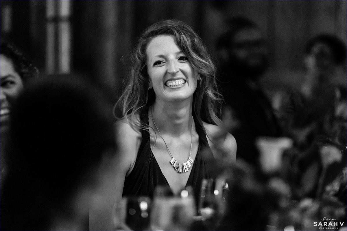 The maid of honor laughs during the dinner at the barn wedding reception