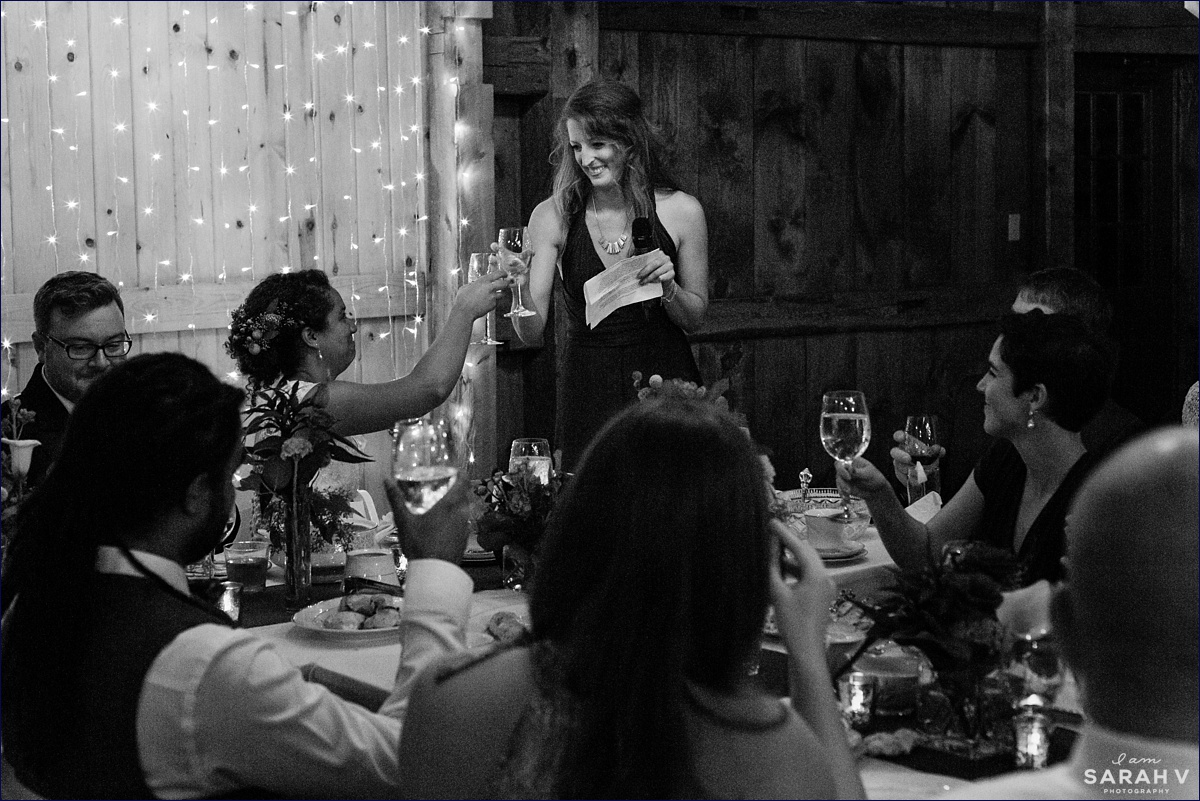 The maid of honor toasts the newlyweds at their barn wedding reception