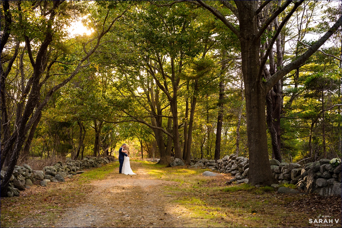The bride and groom stand in the woods by Seacoast Science Center after their New Hampshire elopement