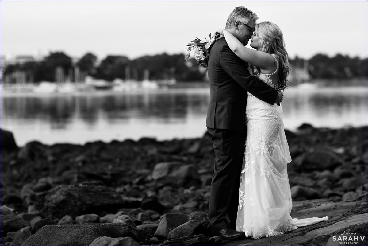New Hampshire Elopement by the Seacoast Science Center the couple kisses on the rocky coastline on their wedding day