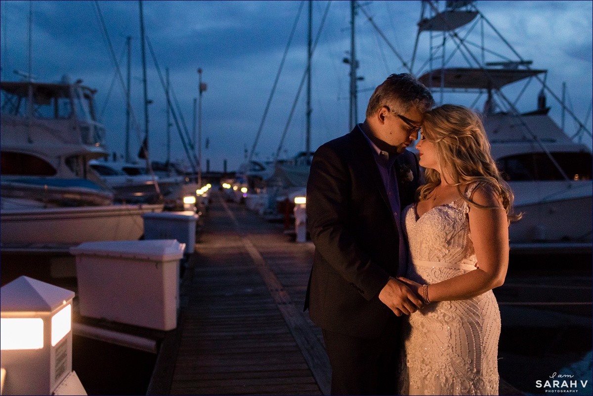 The newlyweds are lit by the lights on the dock at Wentworth by the Sea after they elope