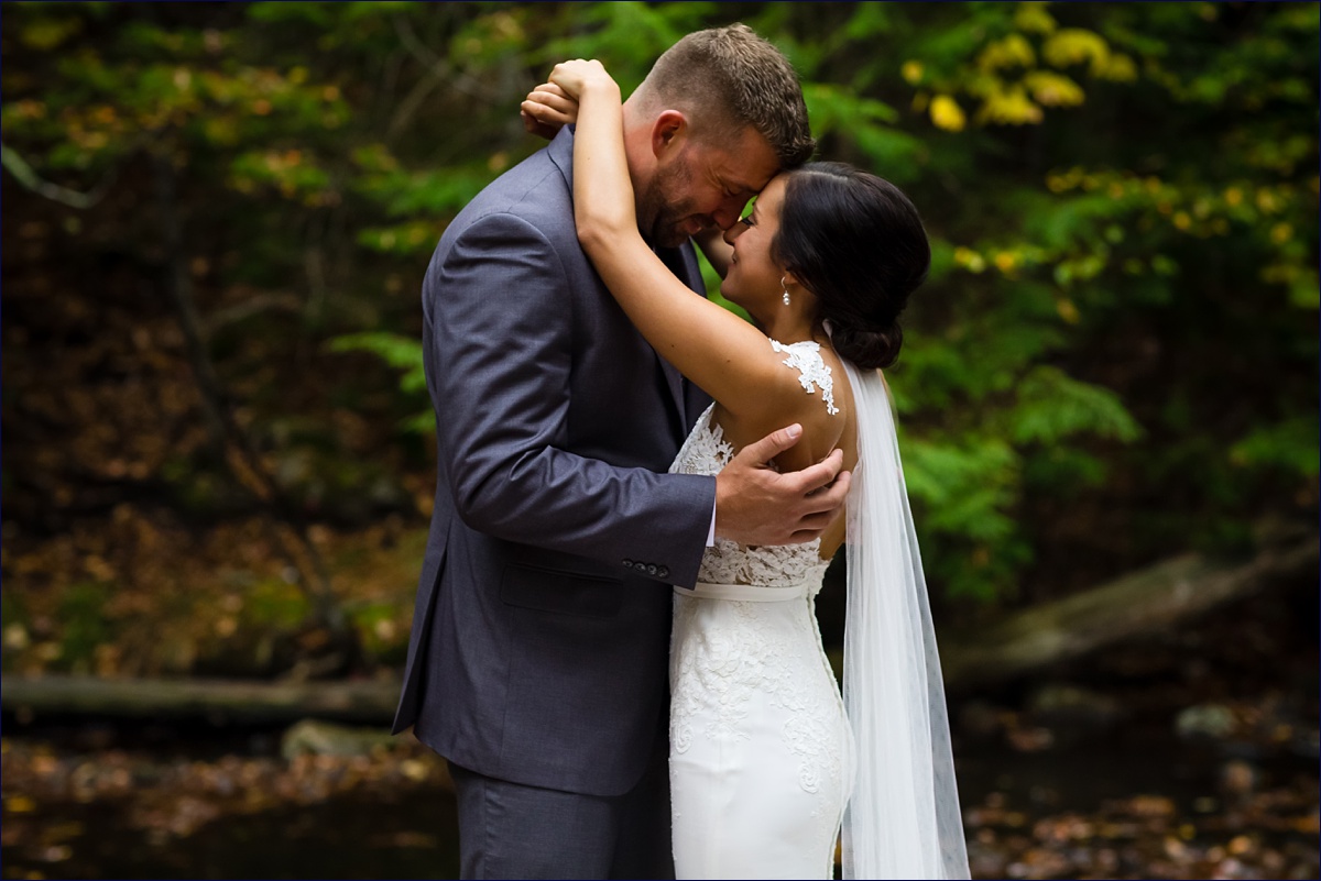 Waterville Valley New Hampshire Wedding bride and groom embrace in the woods after their ceremony