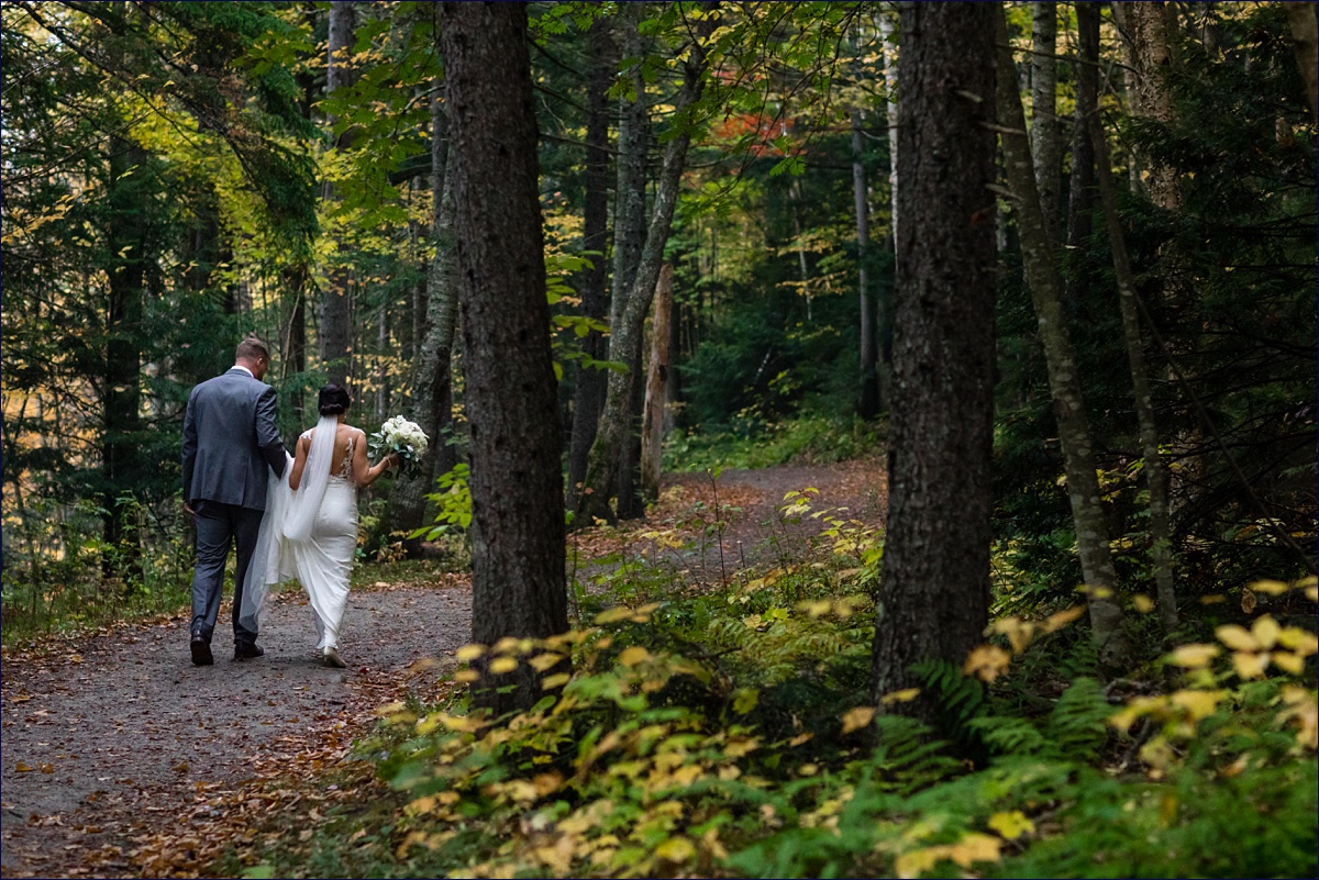 Waterville Valley New Hampshire Wedding bride and groom head back to the reception in the woods